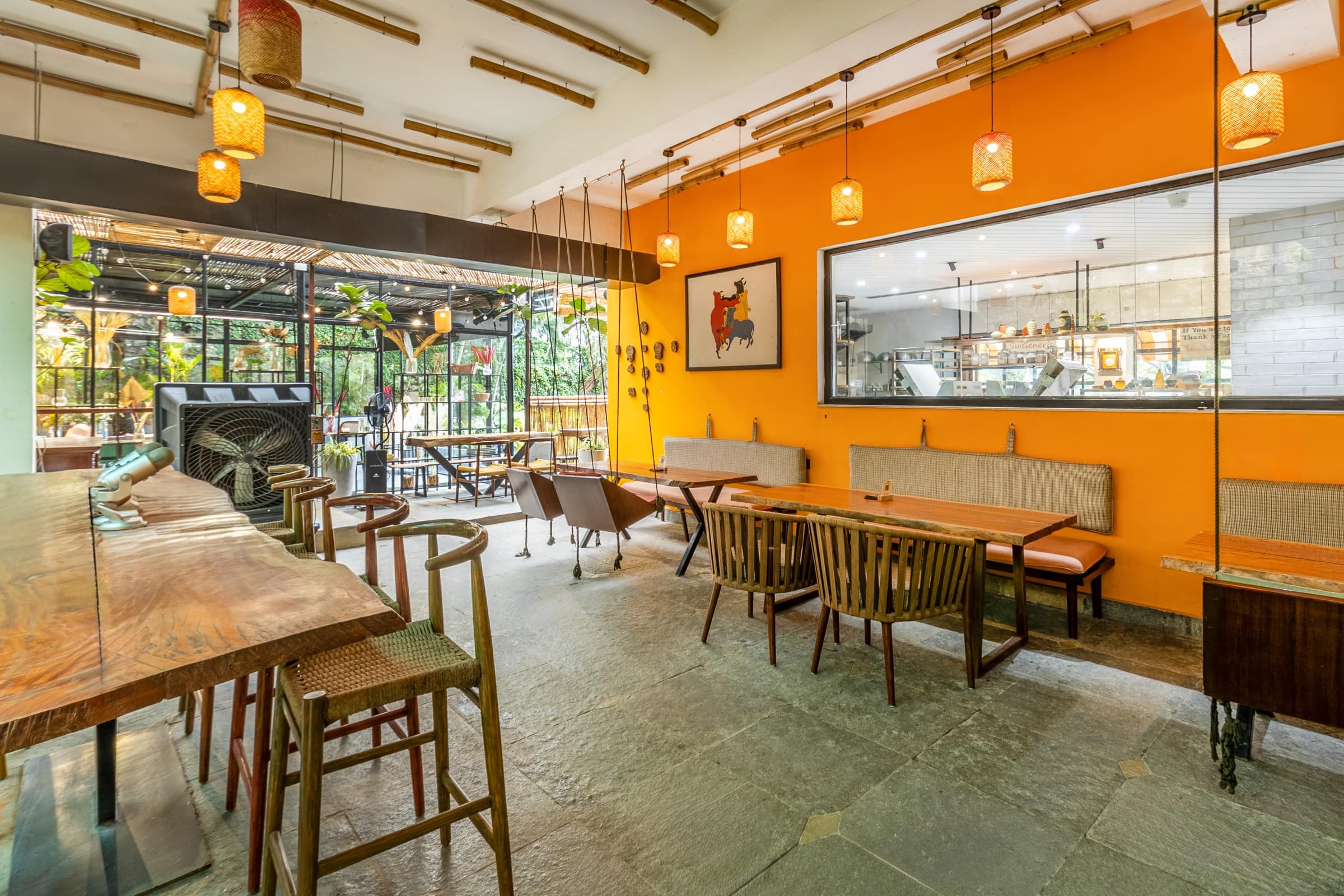 Second dining area with orange wall at Yellolife Cafe